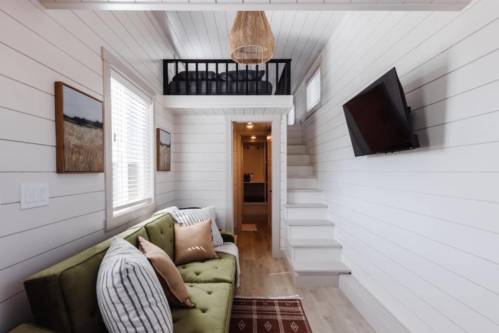 a living room with a couch and a flat screen tv at Pet-Friendly Zion Group Getaway in Apple Valley