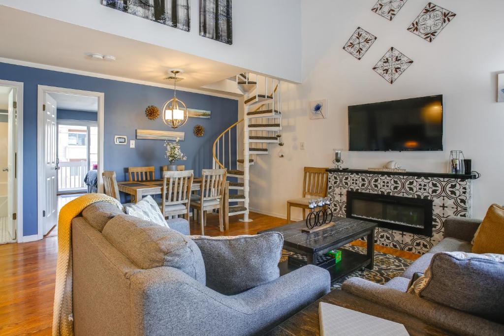 a living room with two couches and a fireplace at Steps to Brigantine Beach: New Jersey Beach Condo in Brigantine