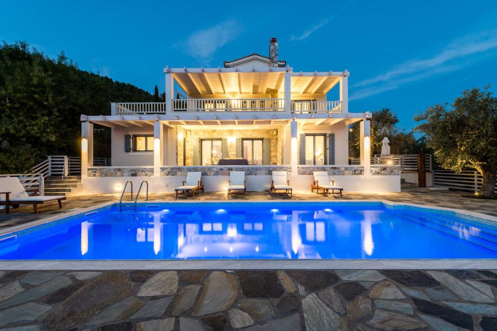 Villa con piscina frente a una casa en Villa Idealia, en Panormos Skopelos