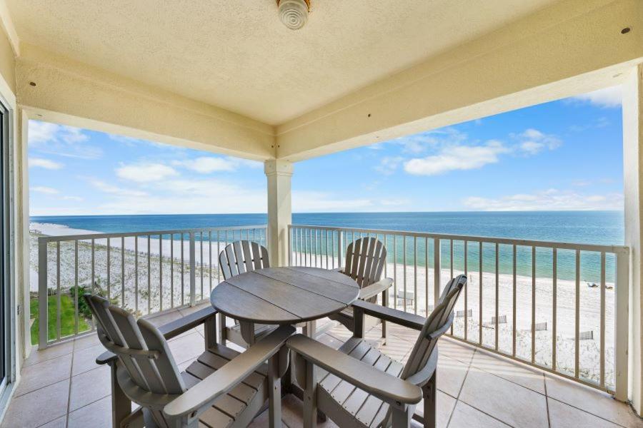 a table and chairs on a balcony with a view of the ocean at Marlin Key 4G by Youngs Suncoast in Orange Beach