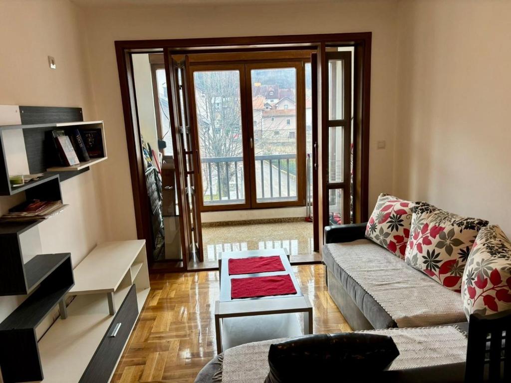 a living room with a couch and a table at Kolasin Rent Apartment in Kolašin