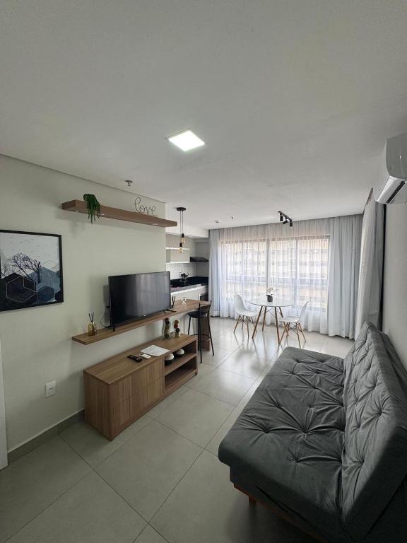 a living room with a couch and a table at Diamond - Flat Bela Estância in São Lourenço