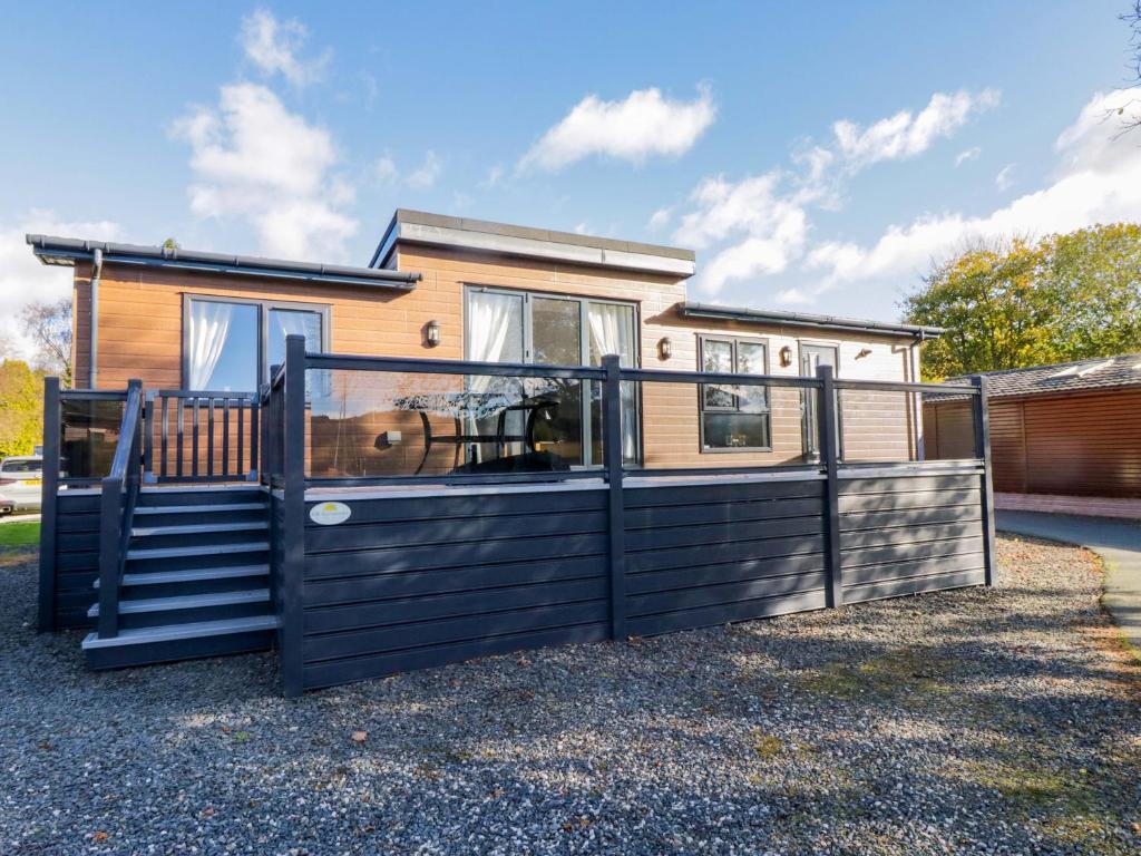 a house with a black fence and a house at 7 Lake View in Windermere