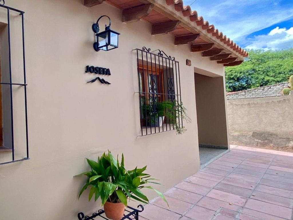 a building with a gate and a potted plant at Casa Josefa Cafayate in Cafayate