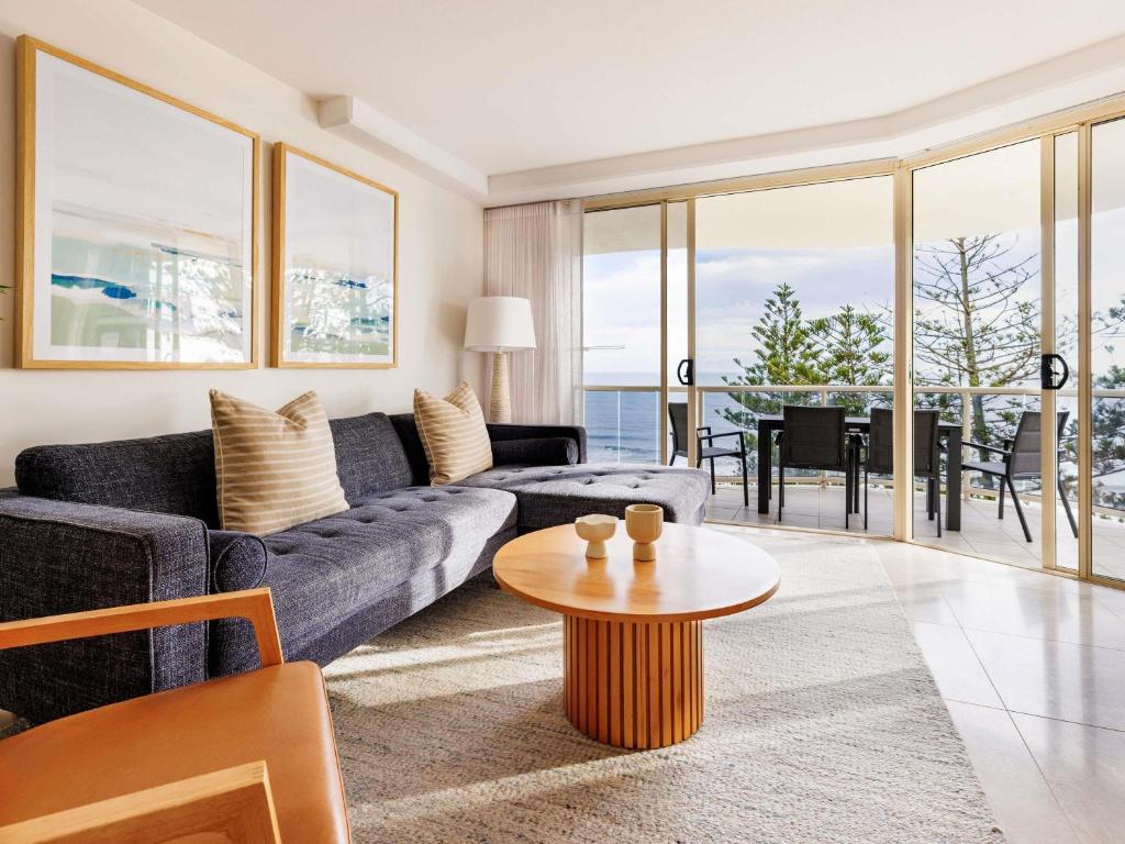 a living room with a couch and a table at Mantra Zanzibar in Mooloolaba