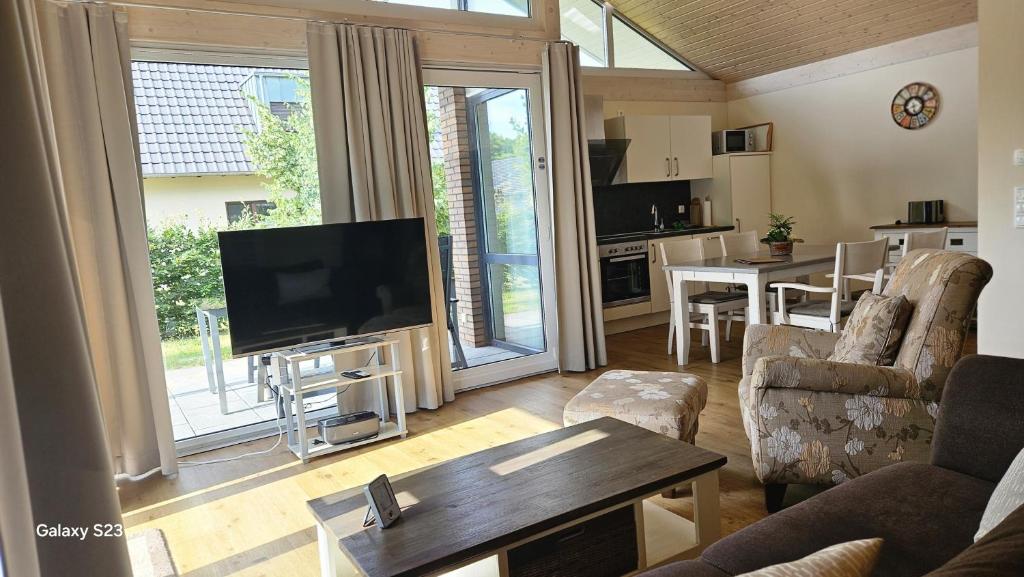 a living room with a flat screen tv and a kitchen at Andreas in Lenz