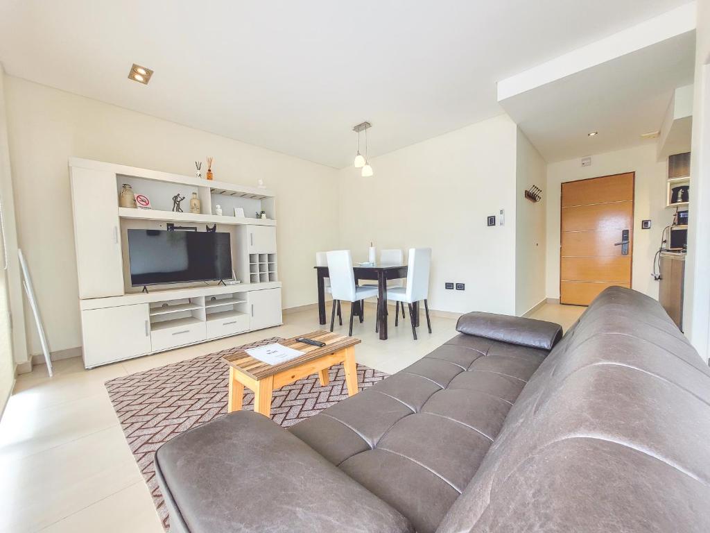 a living room with a couch and a table at Brisa Austral Comodoro in Comodoro Rivadavia