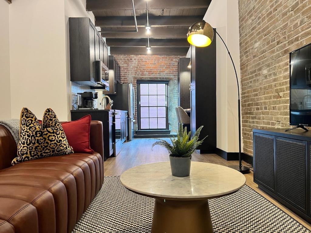 a living room with a couch and a table at Brick & Bed Riverfront Lofts, T 410 in Saint Louis