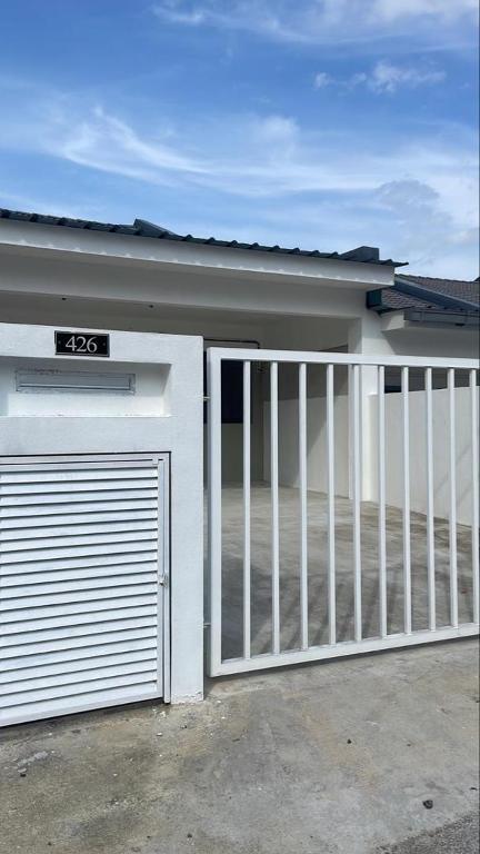 a garage door with a gate in front of a house at Raub Colonial Homestay in Raub