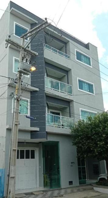 a tall building with a street light in front of it at Hotel Algaroba Anexo in Bom Jesus da Lapa