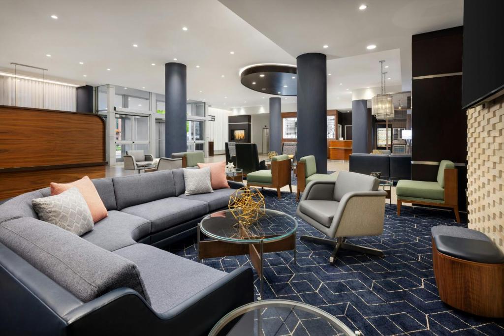 a lobby with a couch and chairs in a building at Courtyard by Marriott New York Manhattan Upper East Side in New York