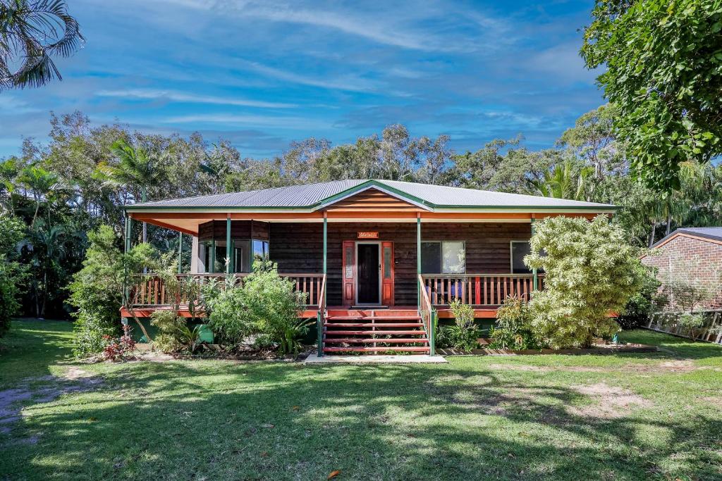 a wooden house with a porch and a yard at Merindah • Pet-Friendly • Central 4BDR for 10 in Agnes Water