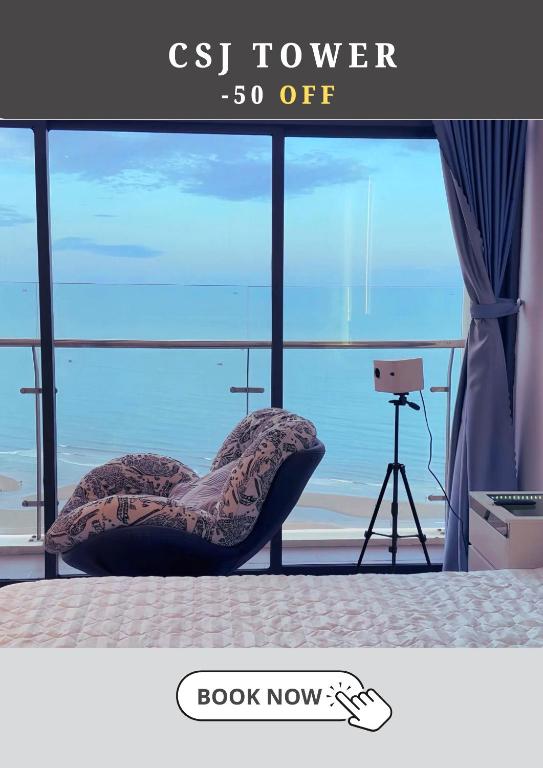a room with a chair in front of a window at CSJ Tower Seaview Apartment -Luxury Near Back Beach Vung Tau City in Vung Tau