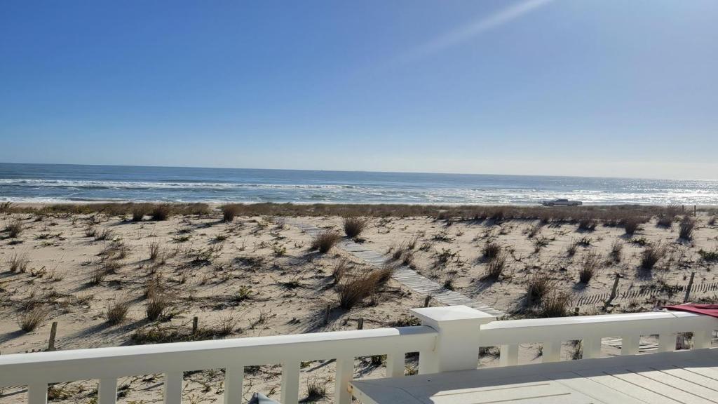 a view of the beach from the balcony of a house at Second Floor Oceanfront Unit in Brant Beach