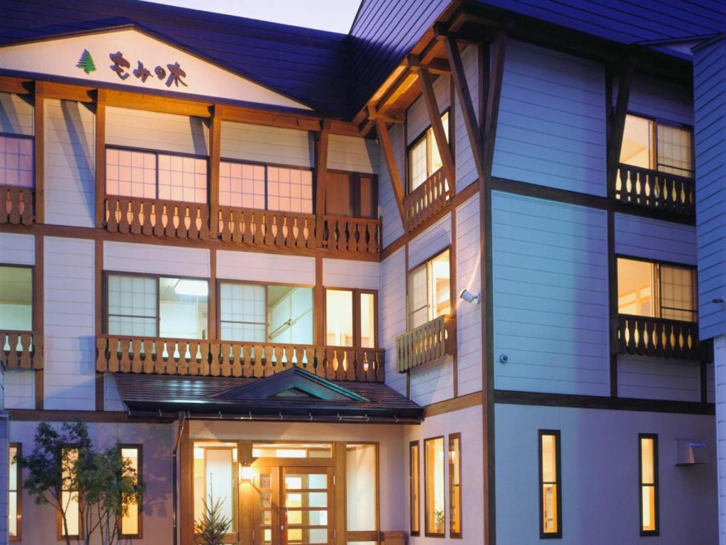 an exterior view of a house with blue siding at Mominoki in Nozawa Onsen