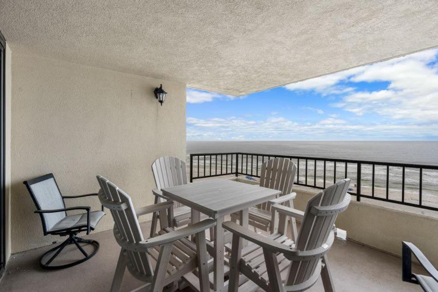 a table and chairs on a balcony with the ocean at Perdido Quay 501 by Youngs Suncoast in Orange Beach