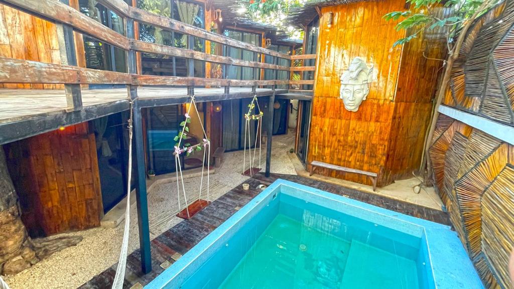 a house with a swimming pool in a building at Mr Pakal Tulum in Tulum