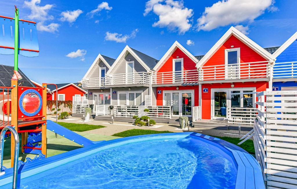 a house with a swimming pool in front of a house at Stunning Home In Sarbinowo in Sarbinowo