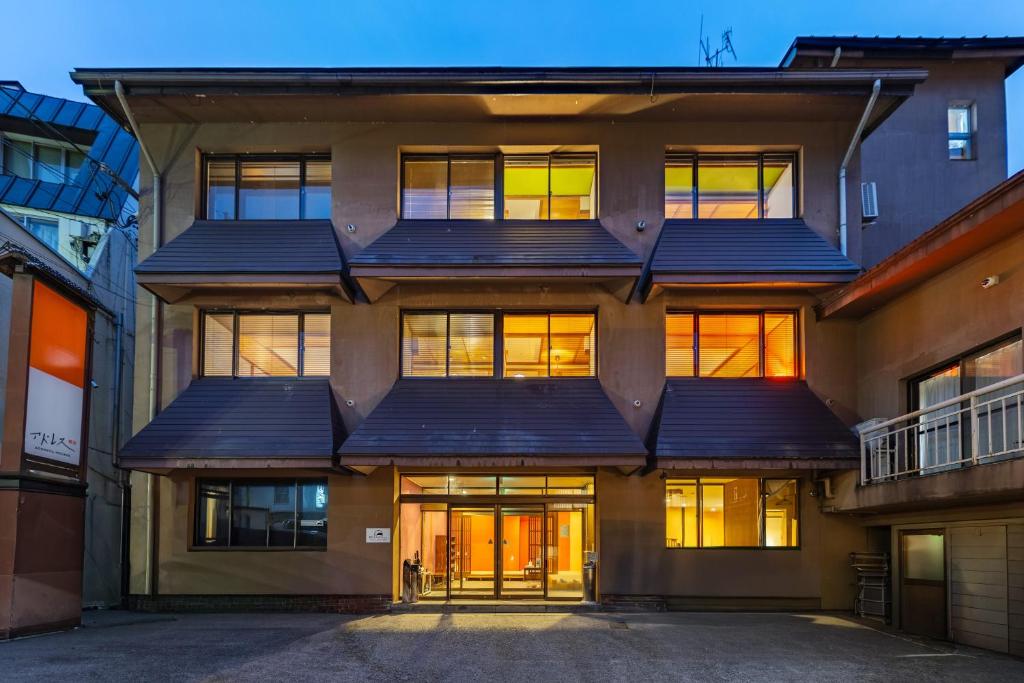 an apartment building with solar panels on the facade at Address Nozawa in Nozawa Onsen