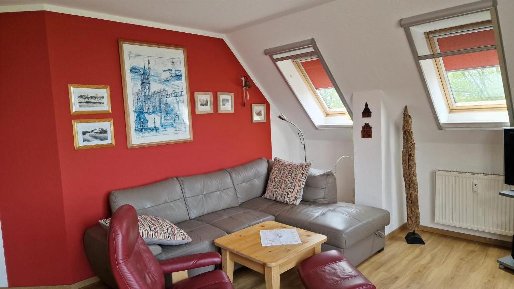a living room with a couch and a table at Schöner Blick in Am Schwarzen Busch