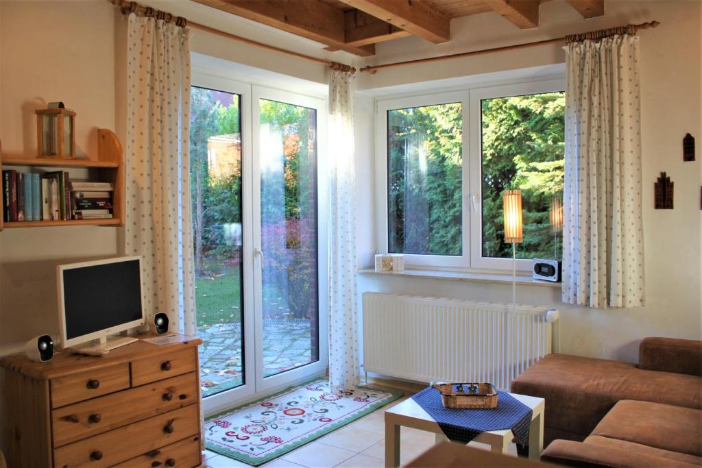 a living room with a large window and a television at Lütt Eddy in Kaltenhof