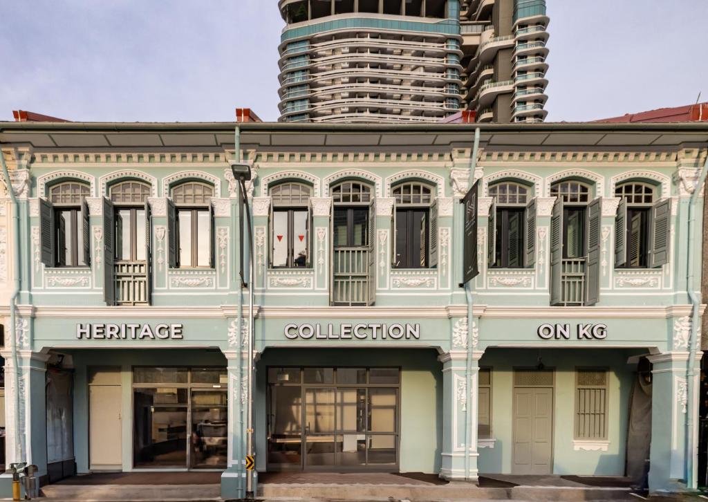 a building in front of a tall building at Heritage Collection on KG - Mobile App Check-In in Singapore