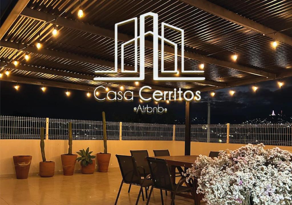 a restaurant with a table and chairs and a sign at Casa Cerritos in Comitán