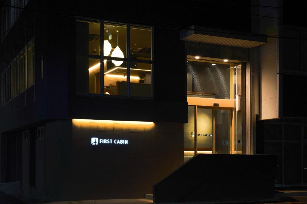 a building with a first command sign on the side of it at ファーストキャビン松江 in Matsue