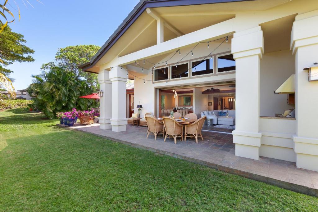 a house with a patio and a yard at ❤PiH❤ Aloha Palms~ Fully Detached Home Beach Gear Bikes in Waikoloa