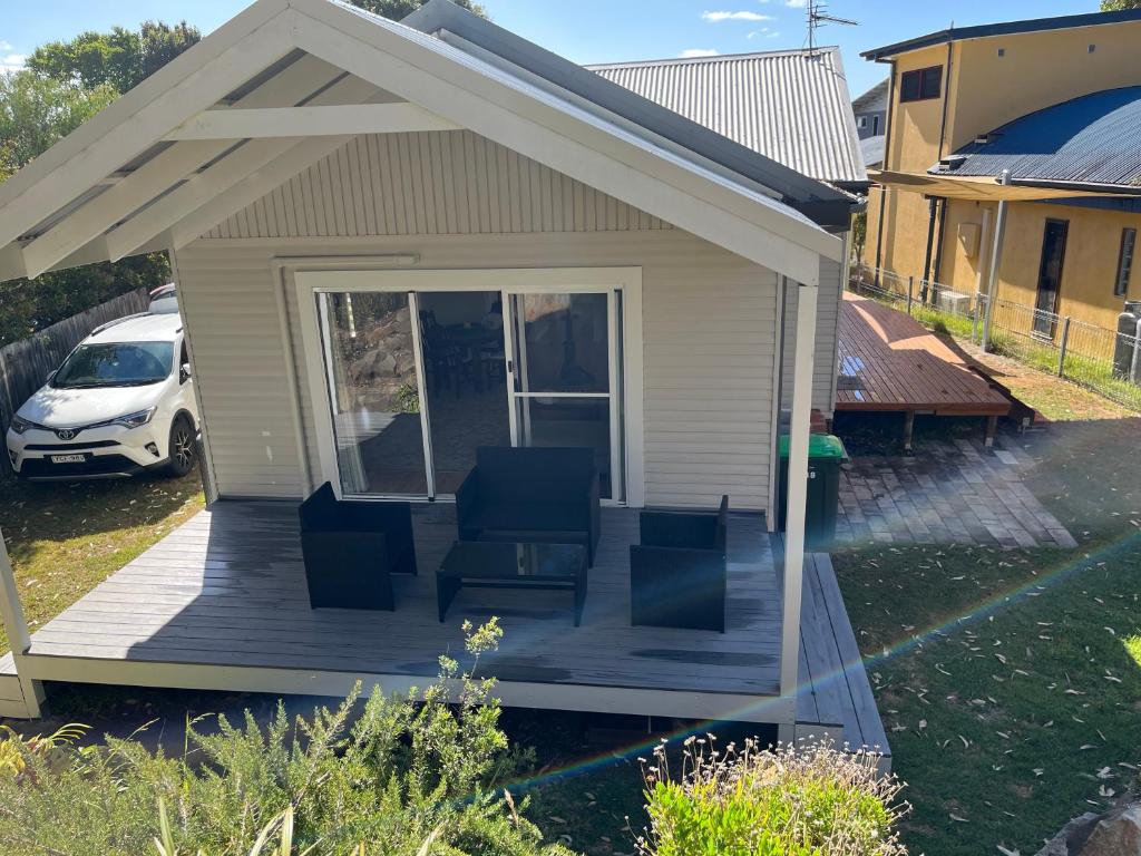 a porch with two chairs on a house at Moruya Heads Constable Street in Moruya Heads