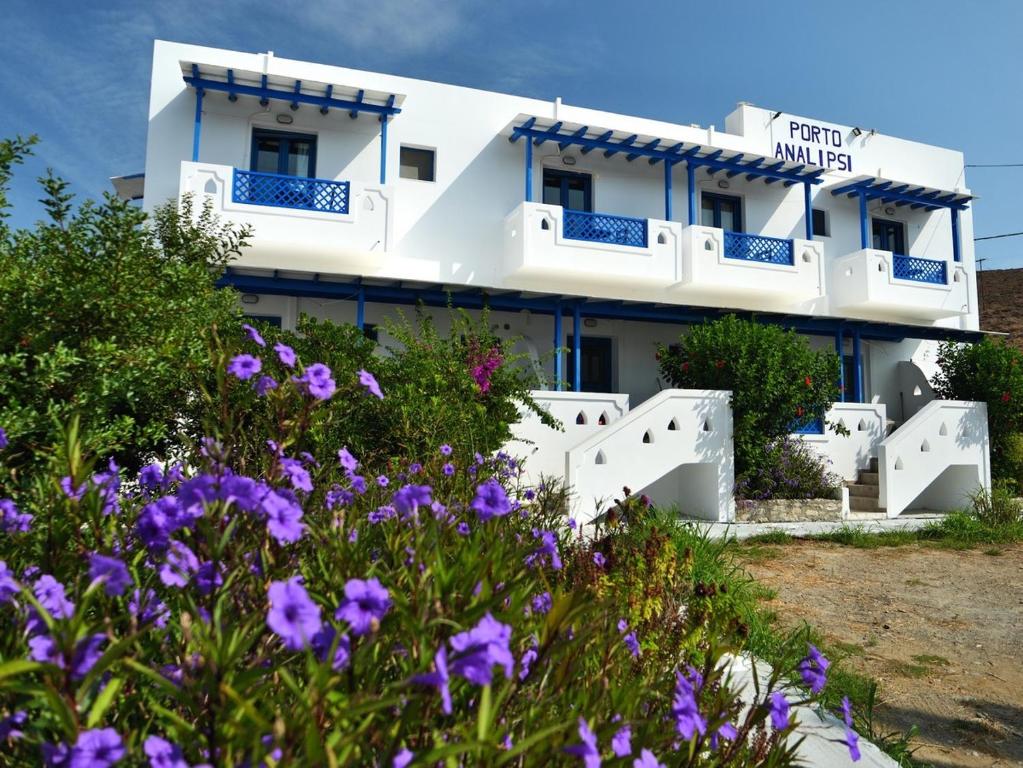 a building with purple flowers in front of it at Porto Analipsi in Maltezana