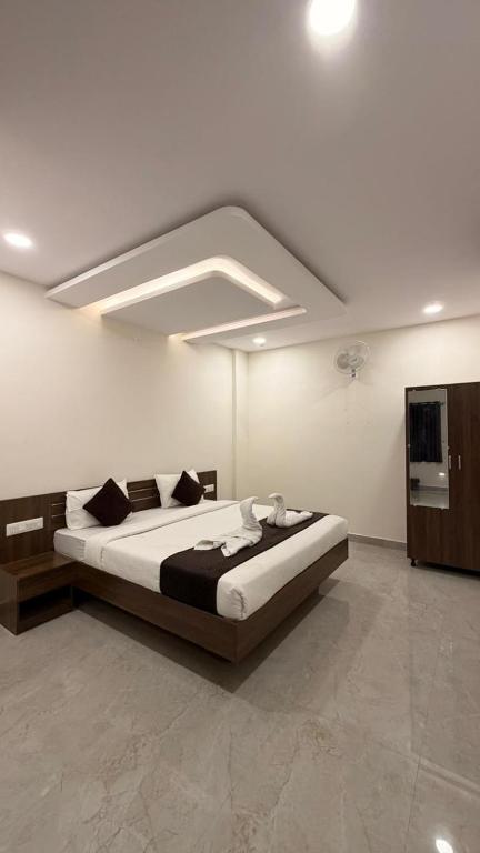 a bedroom with a large bed in a room at SKB Suites in Mysore