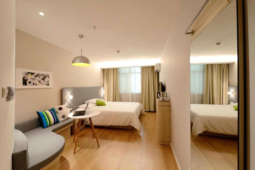 a hotel room with two beds and a table at Hotel IVY in New Delhi