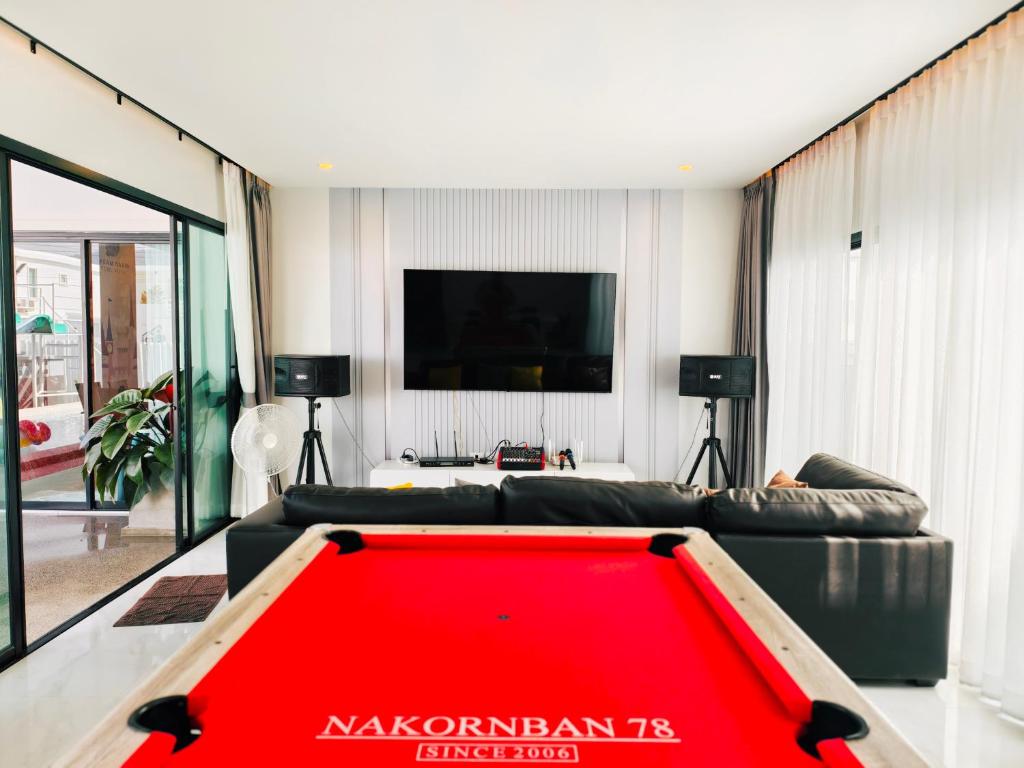a living room with a red pool table at Pool villa Cream Darin in Ban Hua Phrong