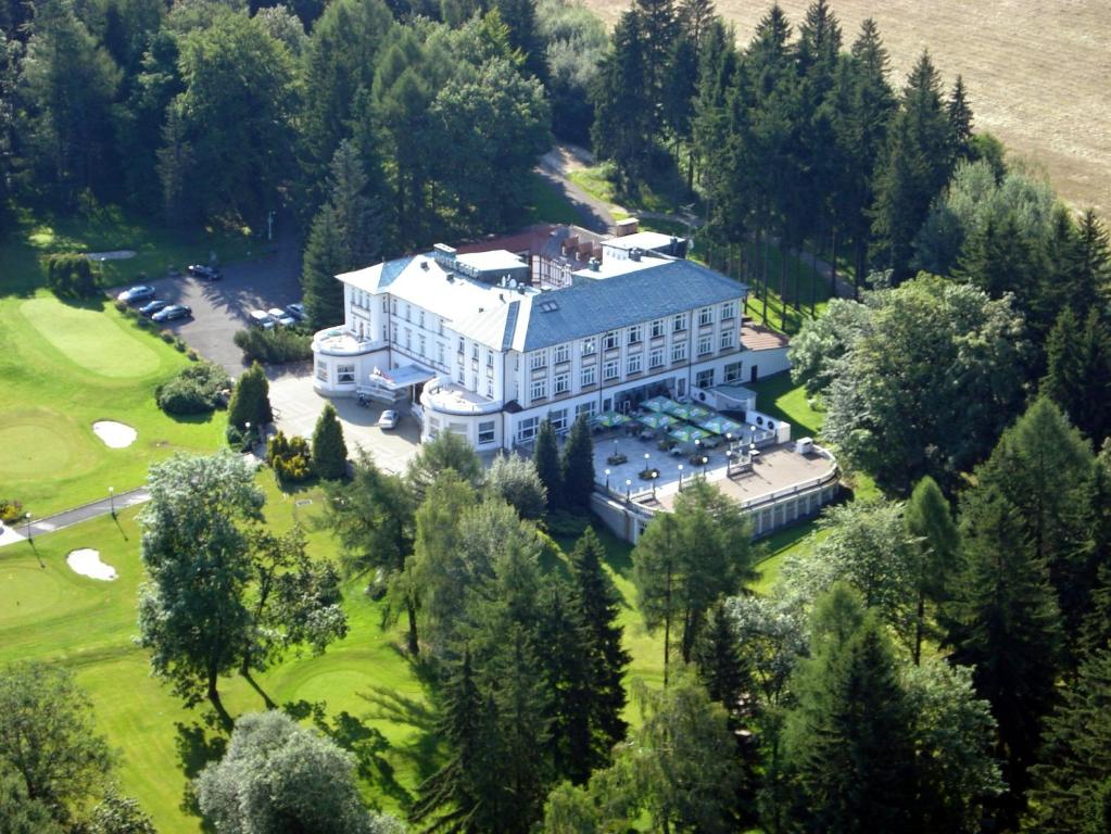 an aerial view of a large building with a golf course at Parkhotel Golf Marianske Lazne in Mariánské Lázně