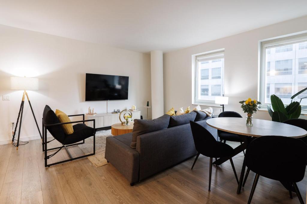 a living room with a couch and a table at Stylish NYC Haven Steps to Broadway & Dining in New York