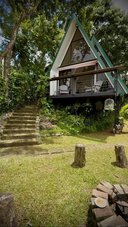 a small house with a green roof on top of a yard at Casa Jardin BV in San Antonio