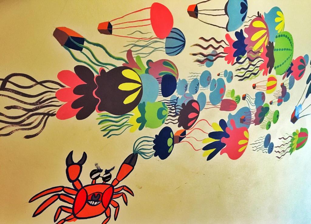 a wall with a painting of crabs on it at Camellia B&amp;B in Taitung City