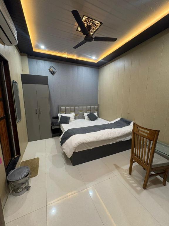 a bedroom with two beds and a ceiling fan at Hotel Riverviewinn in Varanasi