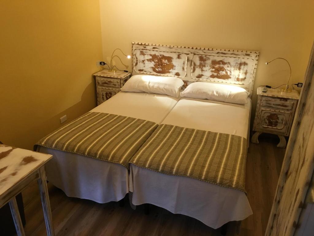 Postel nebo postele na pokoji v ubytování Albergo La Pace