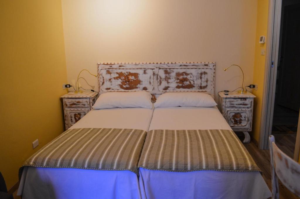Postel nebo postele na pokoji v ubytování Albergo La Pace