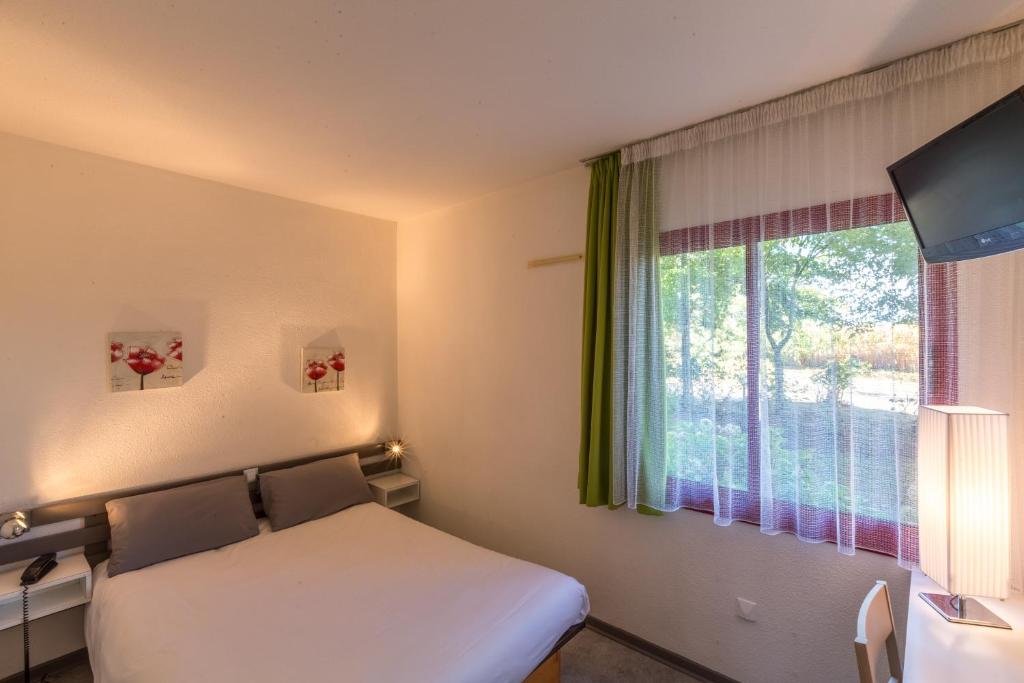 Postel nebo postele na pokoji v ubytování Aliotel