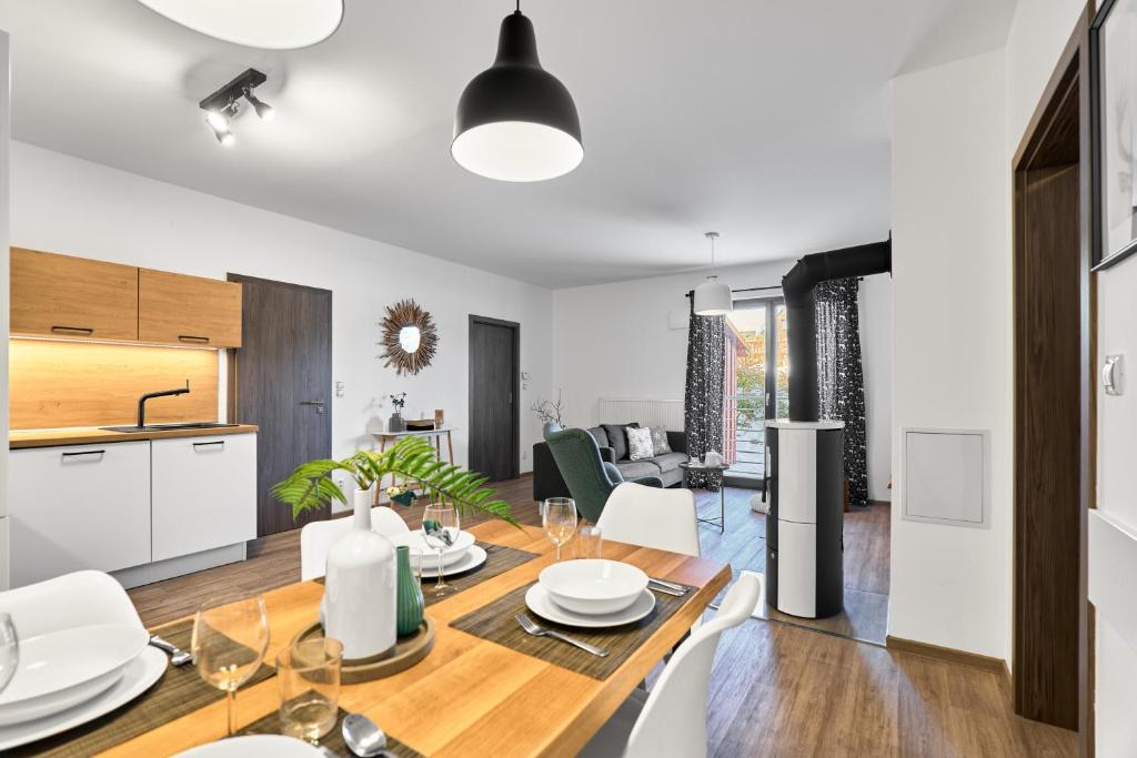 a kitchen and dining room with a table and chairs at Apartmány BD Boží Dar by Mountain ways in Boží Dar