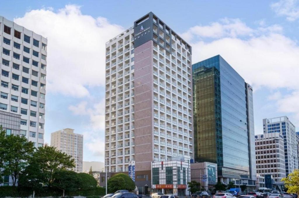 a group of tall buildings in a city at Busan CONNECT Ocean Hotel in Busan