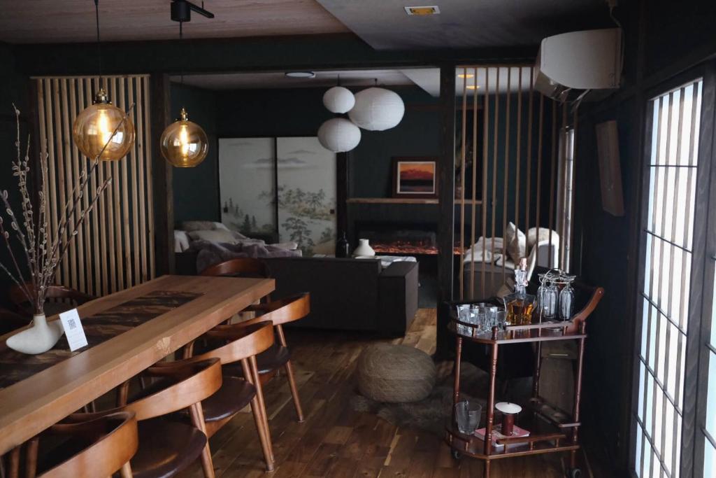 a living room with a table and a couch at Sugi Crossroads in Myoko