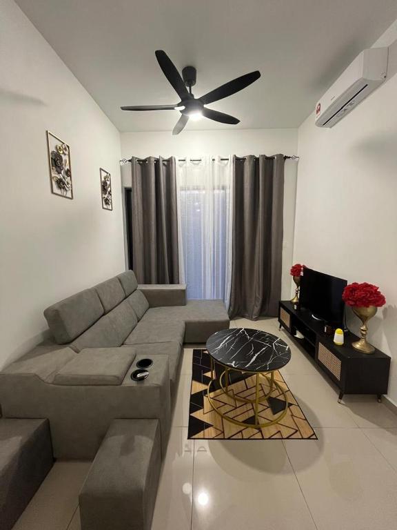 a living room with a couch and a ceiling fan at De' Moysis Homestay in Batu Caves