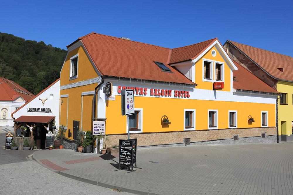 a large yellow and white building on a street at Country Saloon in Vranov nad Dyjí