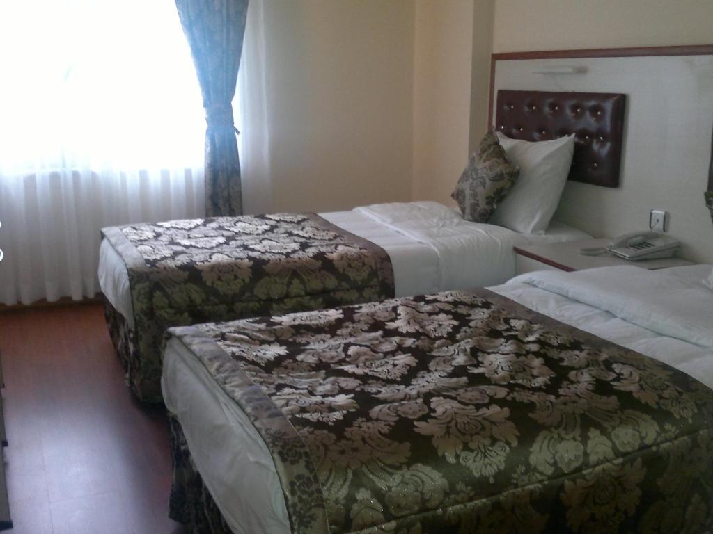 Ліжко або ліжка в номері Tayhan Hotel