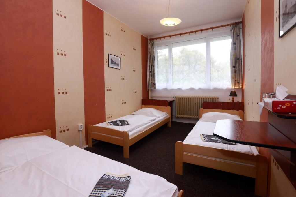 Łóżko lub łóżka w pokoju w obiekcie Hotel Zimní stadion Náchod
