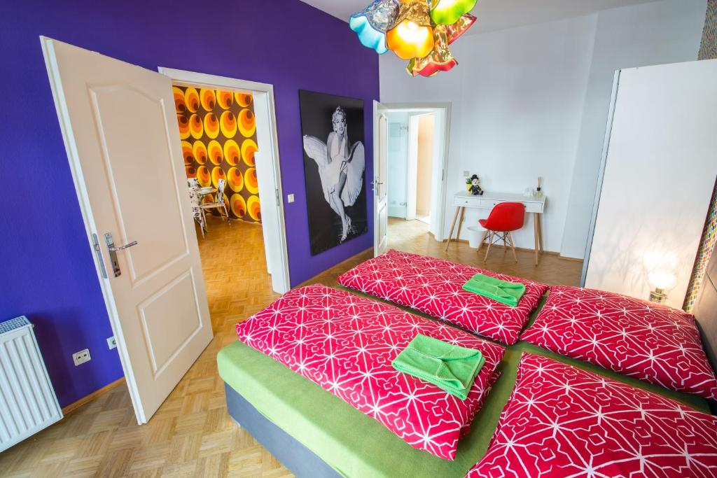 a bedroom with a bed with a red comforter at City Residences Koblenz in Koblenz